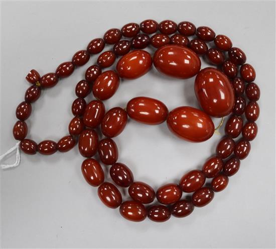 A single strand graduated simulated amber bead necklace, gross weight 80 grams, 84cm.